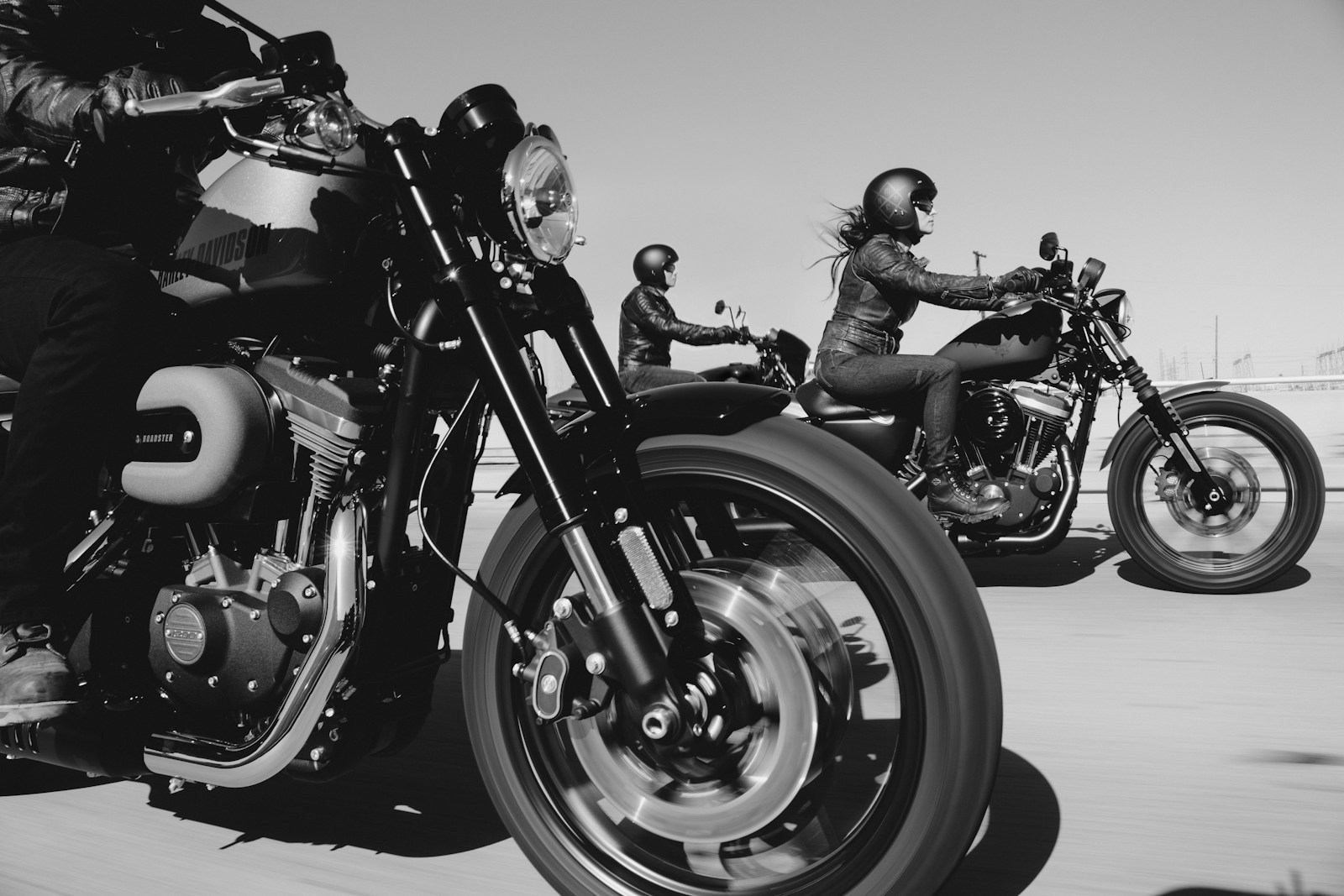 black and white photo of people with motorcycle insurance riding motorcycles